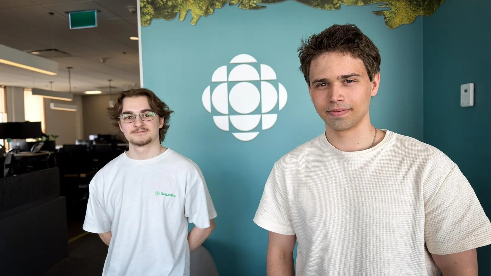 Nicolas and a friend standing inside a CBC office
