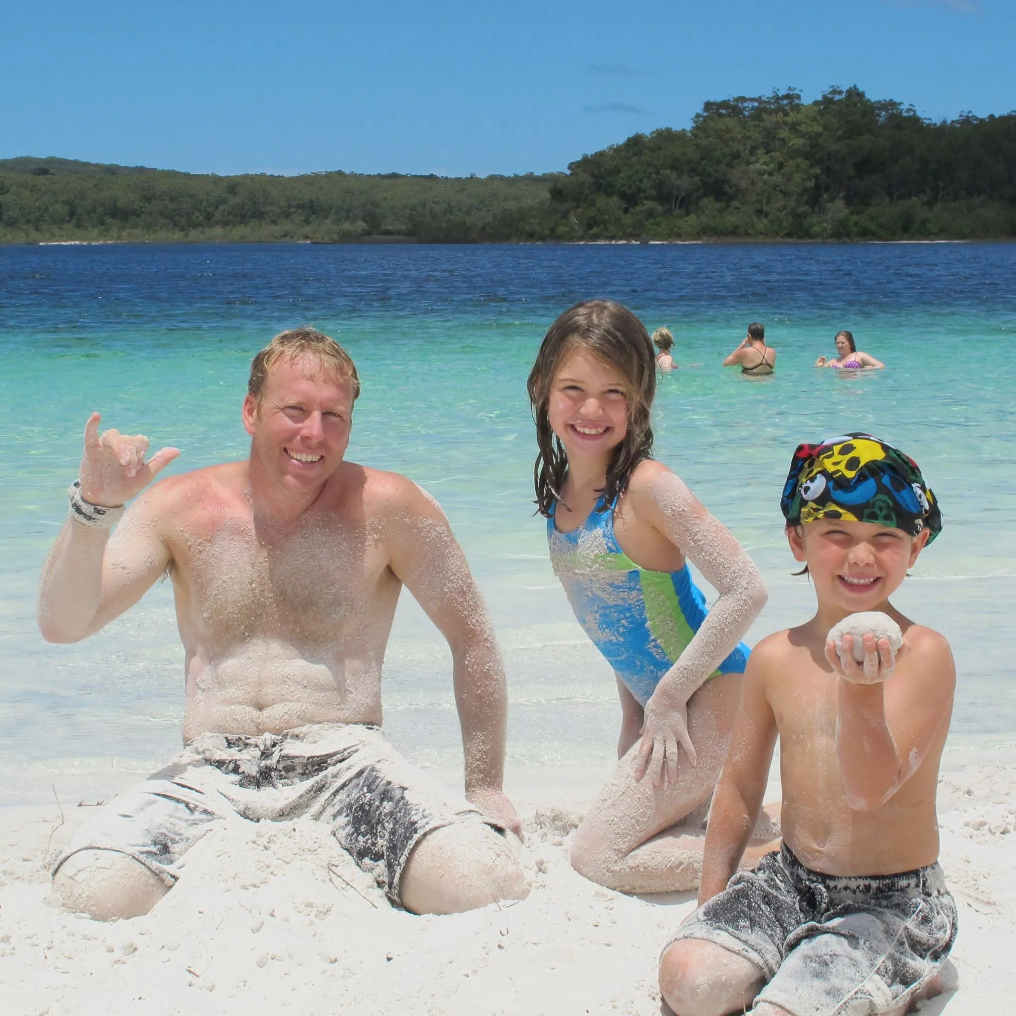 A childhood family photo on a bright beach