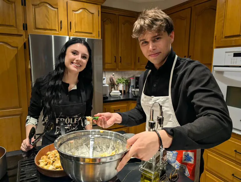 Nicolas cooking with someone in a home kitchen