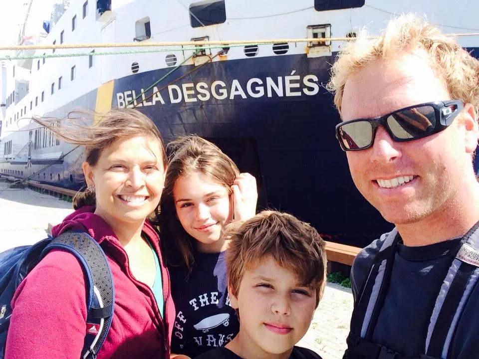 A family taking a selfie beside the Bella Desgagnés ferry