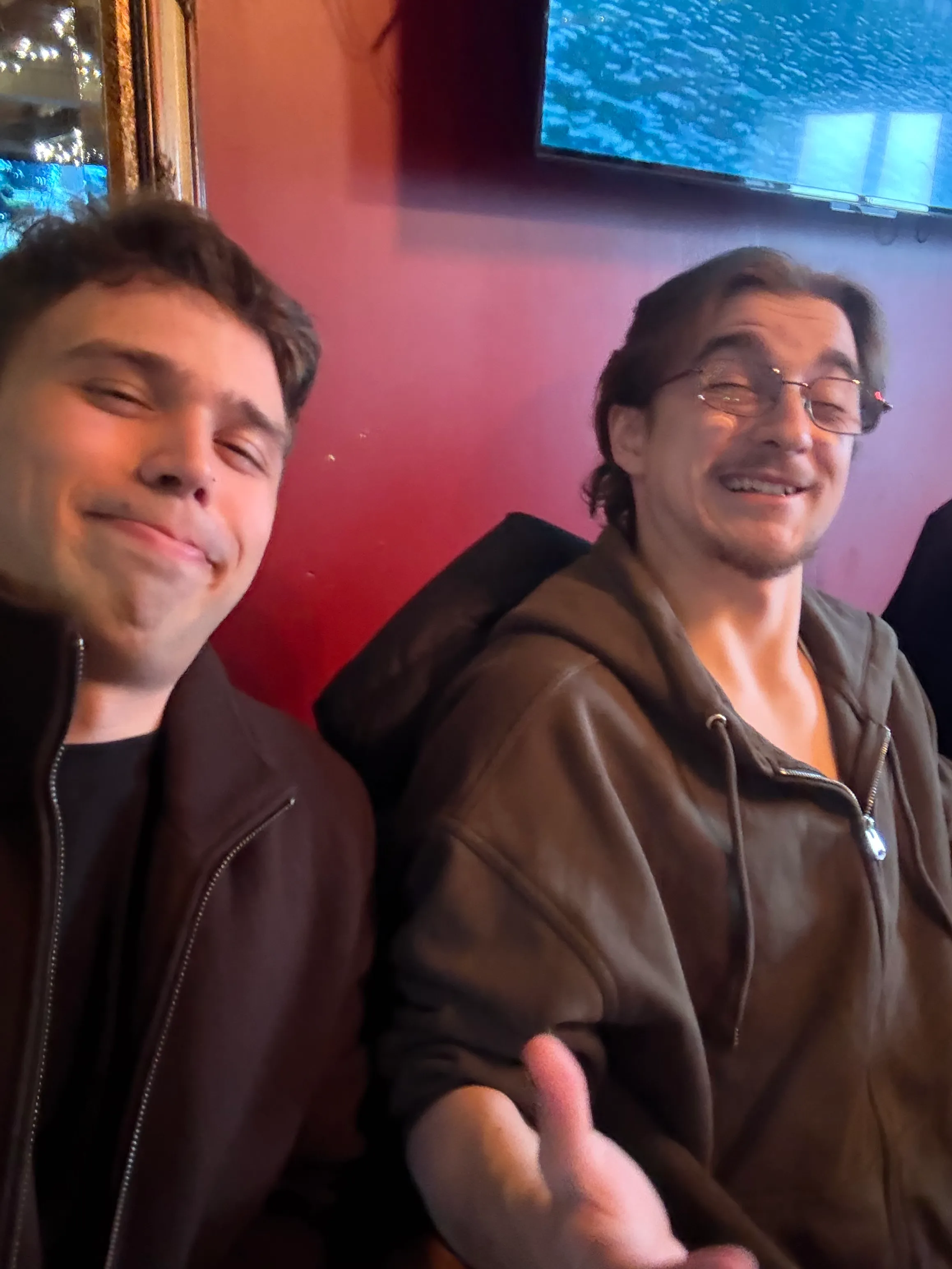 Nicolas taking a smiling selfie with a friend