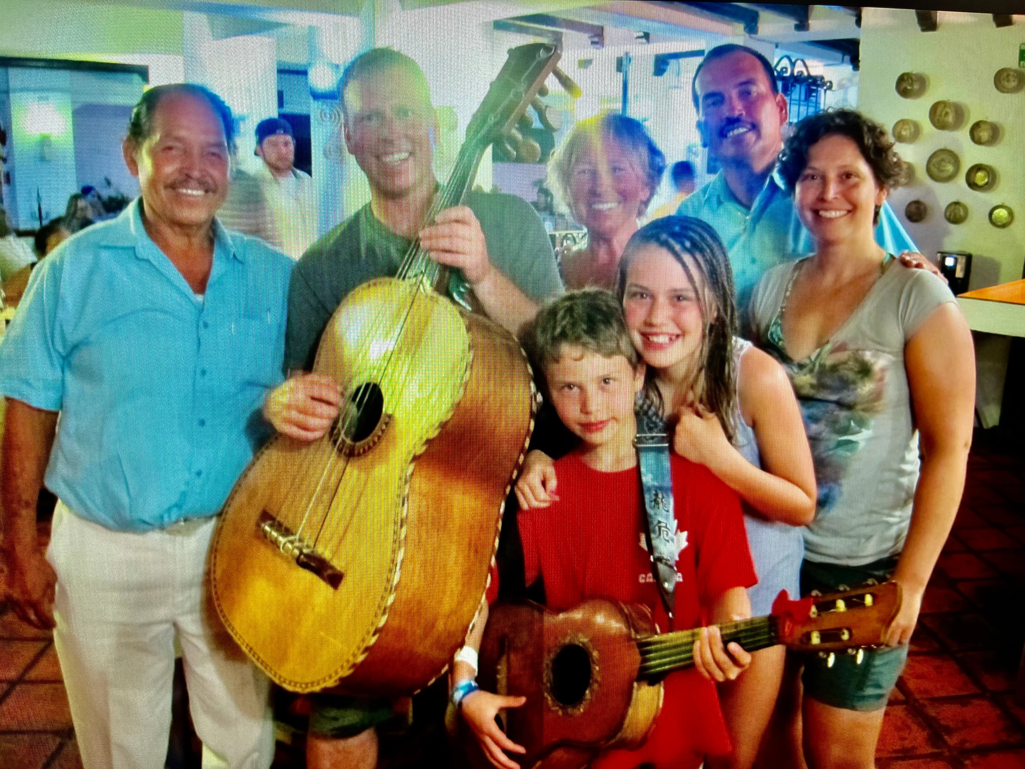 A family posing with musicians and guitars